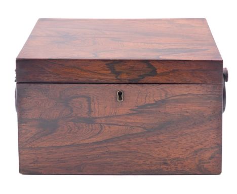 A Regency rosewood tea caddy, early 19th century; of rectangular form, with a ring handle at each end; the interior with twin