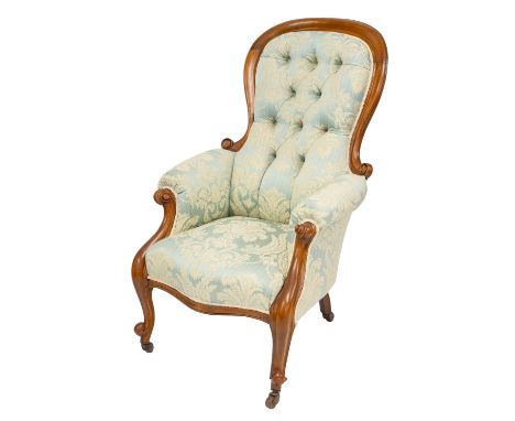 A Victorian walnut and button upholstered 'spoonback' armchair, circa 1870; with later blue silk Damask coverings; with outsc