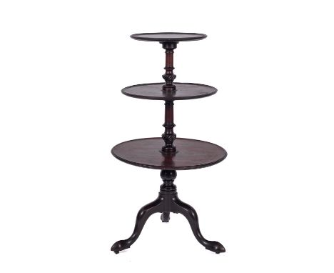 A George III mahogany circular three tier graduated dumb waiter, with dished tops and ring turned spirally fluted vase knoppe