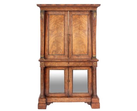A fine Regency mahogany and ormolu mounted collector's cabinet, circa 1815; with moulded cornice above twin panel doors, open
