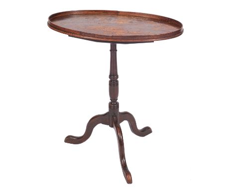 A late George III mahogany oval snap top occasional table, the tray top on ring turned column and tripod splayed legs, the to