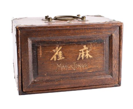 An early 20th century Mah Jong set with five drawers fully fitted with bone and bamboo tiles and gaming pieces, with instruct