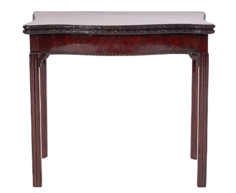 A George III mahogany serpentine front card table, late 18th /early 19th century; the hinged top with foliate and ribbon carv