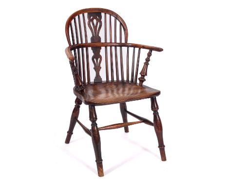 An early 19th Century yew-wood and elm stick back Windsor elbow chair, the back with a pierced and shaped central splat, the 