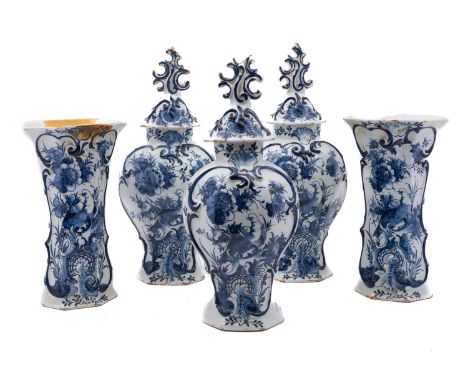 A garniture of five Dutch [Het Bijltje] blue and white delftware vases and three covers, painted with elaborate flower sprays