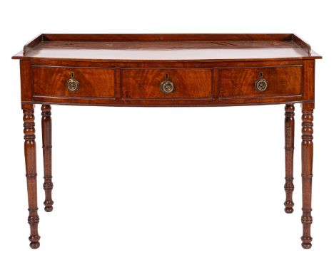 A late 19th Century mahogany bow-fronted dressing table, in Regency style; with a three quarter gallery; containing three fri