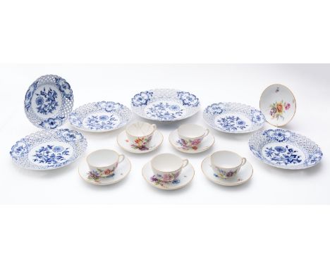 A group of Meissen tableware, comprising six saucers and five cups [one badly damaged] each enamelled with colourful blooms, 