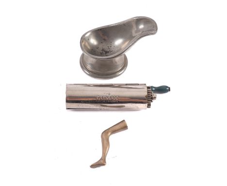 A pewter pipe holder, also 'The Climax' cigarette roller and a brass pipe tamper in the form of a lady's leg (3).Provenance: 