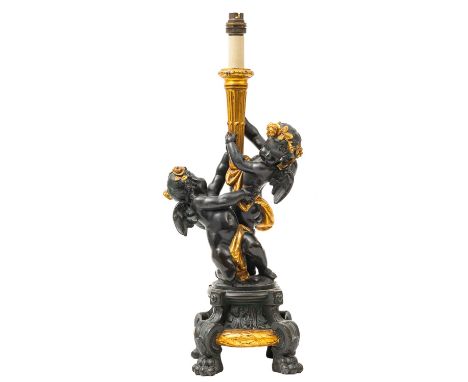 A patinated and painted metal figural table lamp in 18th century style, early 20th century; the electrical fitment set into a