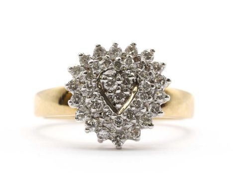 A 9ct gold heart shaped diamond cluster ring, grain and claw set with three rows of brilliant cut diamonds, to a plain shank,