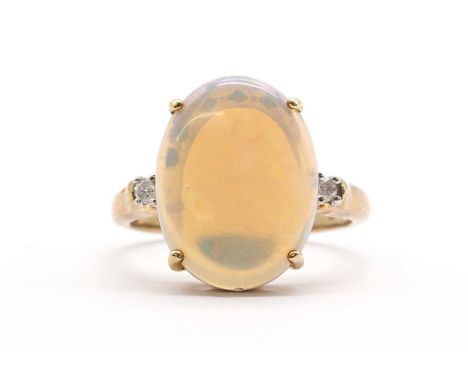 A 9ct gold three stone opal and diamond ring, with an oval cabochon opal, approximately 16 x 12mm, with a brilliant cut diamo