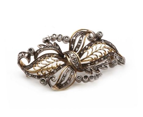 A silver and gold, diamond set spray brooch, with rose cut diamonds grain set in silver, with gold wires, to gold pin and rol