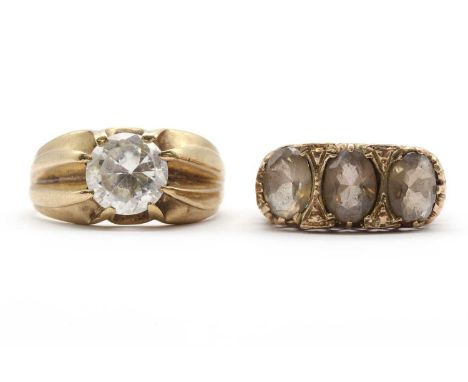 Two 9ct gold rings, comprising a three stone smoky quartz ring, London 1978, and a single stone cubic zirconia ring, common c