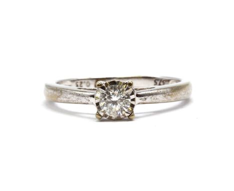 A 9ct white gold single stone diamond ring,with a brilliant cut diamond claw set to an illusion collet, to open shoulders and