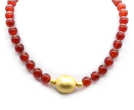 Two beaded necklaces, comprising a cornelian bead necklace with wooden gold leaf beads, to a gold jumbo bolt ring clasp, test