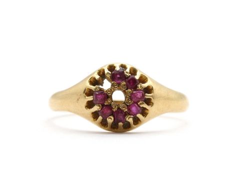 A gold ruby cluster ring,two stones deficient, to tapered shoulders and a 'D' section shank, tested as approximately 15ct gol