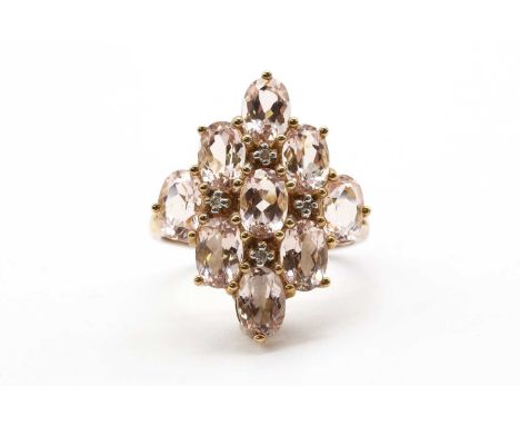 A 9ct gold morganite and diamond cluster ring, the lozenge shaped head set with oval mixed cut morganites, with brilliant cut