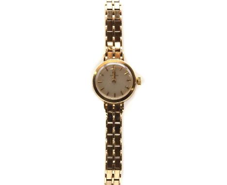 A ladies' 9ct gold Omega mechanical bracelet watch,17mm diameter, with a silvered dial and baton hour markers, to integral br