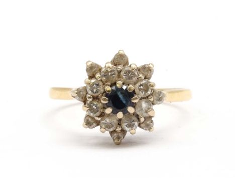 An 18ct gold sapphire and diamond cluster ring, with a central round mixed cut sapphire, to two row surround of brilliant cut