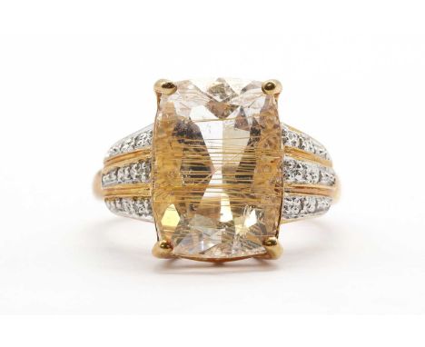 A 9ct gold rutilated quartz and diamond ring, with a cushion cut rutilated quartz, approximately 14 x 10mm, to tapered should