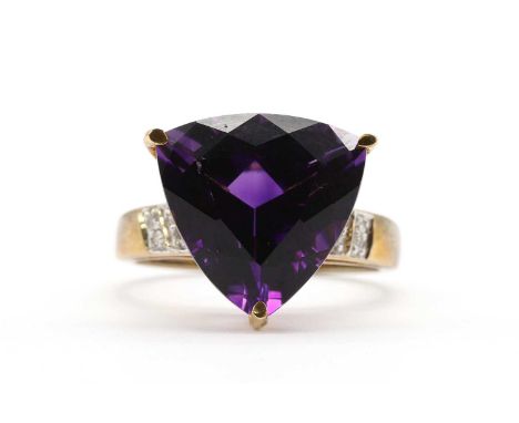 A 9ct gold amethyst and diamond ring, a triangular mixed cut amethyst, approximately 14mm, claw set, to shoulders grain set w