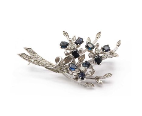 An 18ct white gold sapphire and diamond spray brooch, with oval mixed cut sapphires, Swiss and eight cut diamonds, all claw o