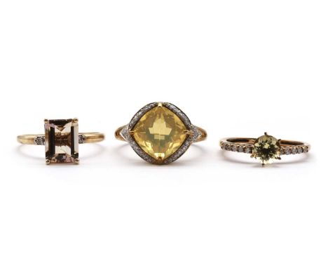 Three 9ct gold rings, comprising a citrine and diamond ring, Birmingham, a heliodor beryl and diamond ring, Birmingham, and a