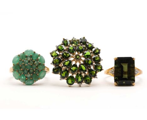 Three 9ct gold rings,comprising an emerald cluster ring, a chrome diopside and diamond cluster ring, and a moldavite and diam