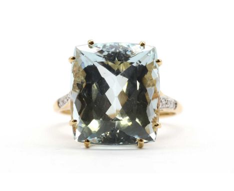 An 18ct gold aquamarine and diamond ring,with a cushion cut aquamarine, approximately 14.3 x 12.4 x 8.9mm, claw set to eight 