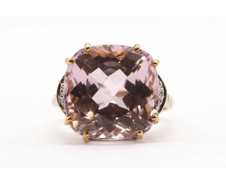 A 9ct gold kunzite and diamond ring,with a cushion cut kunzite, approximately 14mm, to eight cut diamond set shoulders, and a