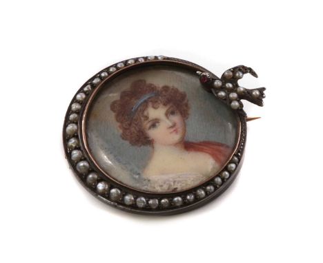 A silver mounted portrait miniature brooch,the portrait miniature beneath a glazed cover, with a crescent of graduated split 