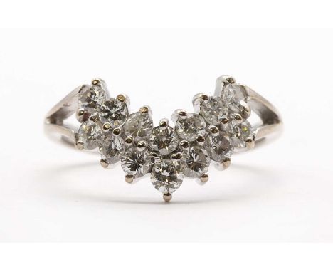 An 18ct white gold shaped two row diamond ring, the curved head claw set with two rows of brilliant cut diamonds, to split sh