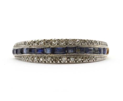 A gold sapphire and diamond ring, a central row of rectangular step cut sapphires, with a row of eight cut diamonds grain set