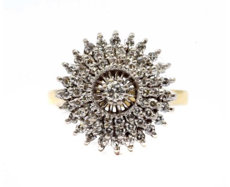 An 18ct gold diamond cluster ring, with a central brilliant cut diamond, to three tier stepped surround of eight cut diamonds