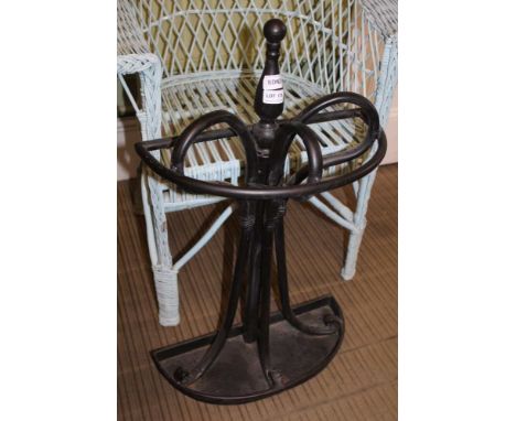 A BLACK PAINTED METAL DEMI-LUNE STICK STAND 