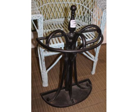 A BLACK PAINTED METAL DEMI-LUNE STICK STAND 