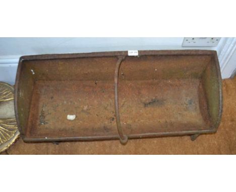 A CAST IRON FEEDING TROUGH 