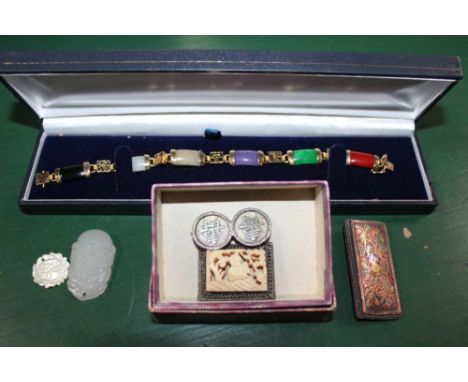 A BAG CONTAINING CHINESE METAL BRACELET set with coloured stones, together with other Chinese brooches, and a small jade carv