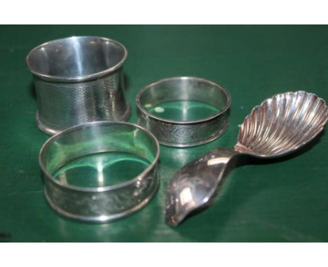 THREE HALLMARKED NAPKIN RINGS together with a silver scalloped bowl, tea caddy spoon 