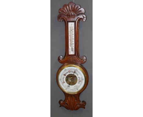 An Edwardian oak aneroid barometer thermometer having enamel registration height 82cm
