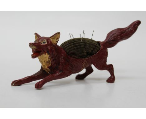 A cold painted bronze pin cushion, cast as a startled fox. 18cm long