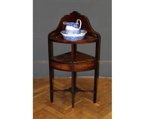 A George III mahogany corner washstand, with a later Wedgwood blue and white jug and basin