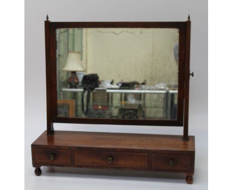 An early 19th century mahogany toilet mirror, with adjustable rectangular plate and three drawer box base 70 x 70 x 25cm