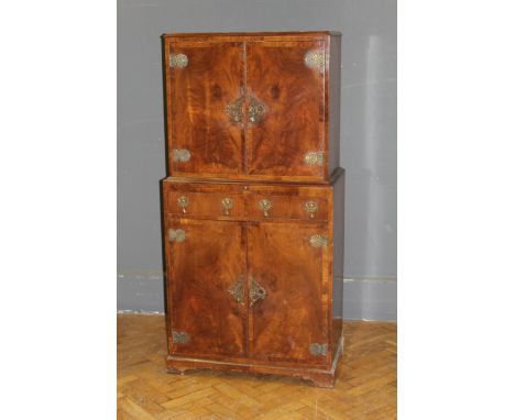 A French style walnut cocktail cabinet, by M&T London LTD, the crossbanded doors with heavy brass hinges and elaborate escutc