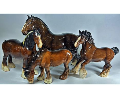 Four ceramic models of Beswick heavy type horses in various poses and sizes, the largest 18cm x 28cm approx