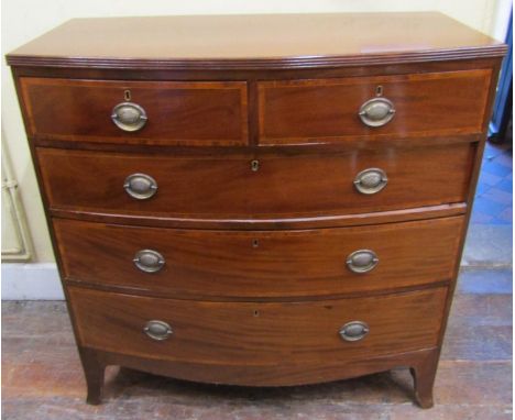 A Georgian mahogany bow front chest of three long and two short graduated drawers, with rosewood crossbanding, on swept suppo