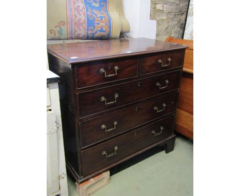 A Georgian mahogany or possibly red walnut bedroom chest of three long and two short graduated oak lined drawers with cast br