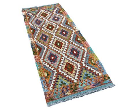 A Chobi kilim runner with a multicoloured all over diamond pattern 250cm x 87cm 