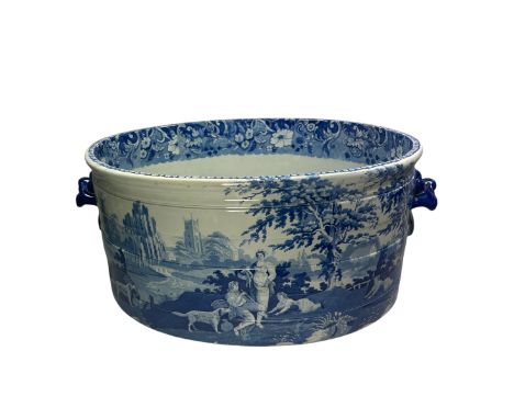 A large and impressive 19th century Davenport blue and white ribbed oval porcelain footbath, printed with a shepherd boy play