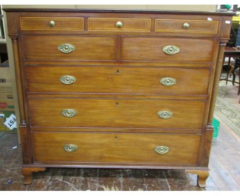 An late Georgian period mahogany chest of three long, two medium, and three small shallow drawers, set within column supports